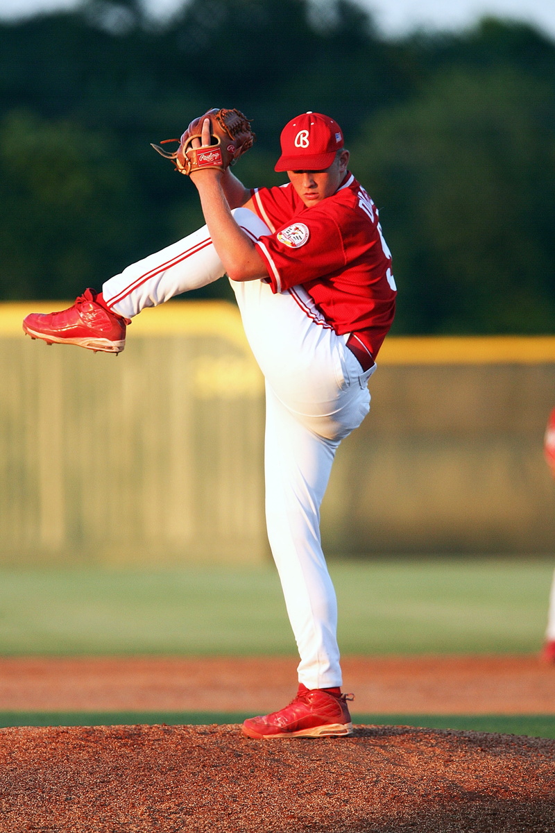 uniform, determination, ball, compete, 2K, red, real people, stretch, mound, field, daytime, competition, pitching, pitch, glove, sports clothing, athlete