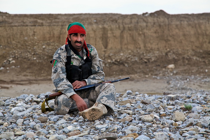 military, rebel, clothing, afghanistan, shooting, one person, nature, mid adult, sitting, men, armed forces, war, day, army, rocks, insurgent, solid, fighter