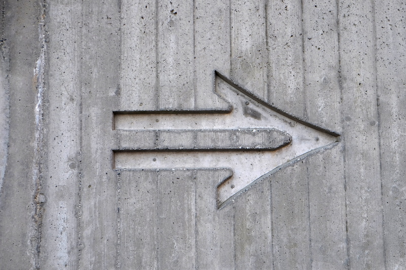 4K, single object, wooden, text, grey, pattern, engraved, arrow, left, communication, close-up, wall, concrete, day, surface, wood - material, wall - building feature