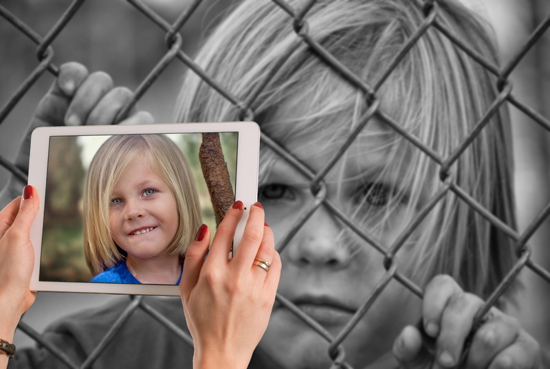 expression, one person, technology, smiling, females, facial expression, sad, childhood, laugh, fence, hairstyle, girls, contradictory, offspring, holding
