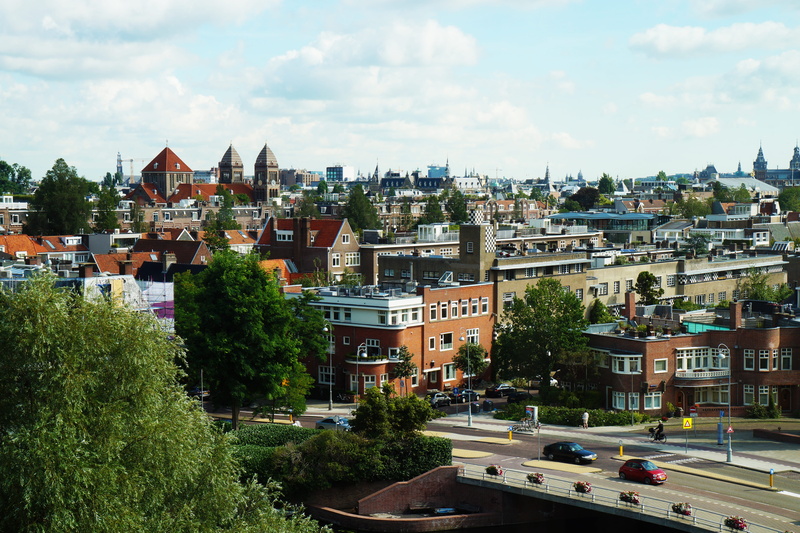 cars, clouds, cloud - sky, tree, transportation system, built structure, street, sight, high angle view, foliage, buildings, city, apartment, outdoors