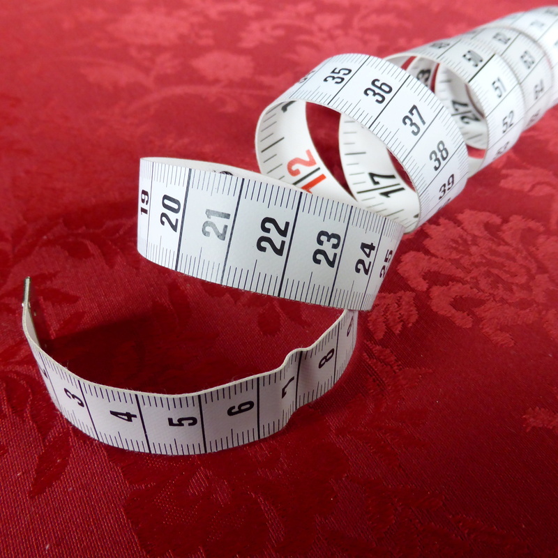 white color, gage, dieting, studio shot, red background, close-up, inch, positive emotion, red, no people, number, slim, tape, heart shape, still life