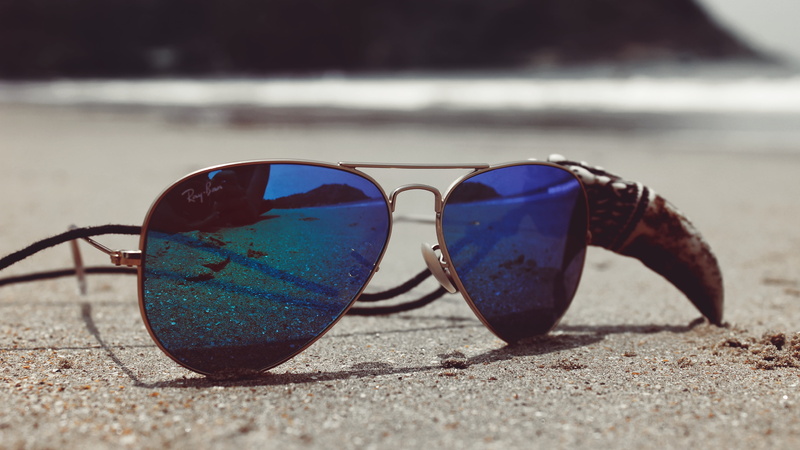 glasses, close up, shadow, sand, macro photography, eyewear, land, surface level, outdoors, reflection, security, water, sunglasses, 5k, focus on foreground
