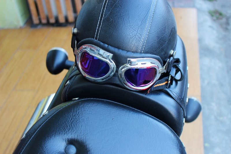 real people, indoors, blue, shoe, Helmet, icon, human limb, human body part, leisure activity, equipment, day, motorcycle, human leg, black, design, close-up