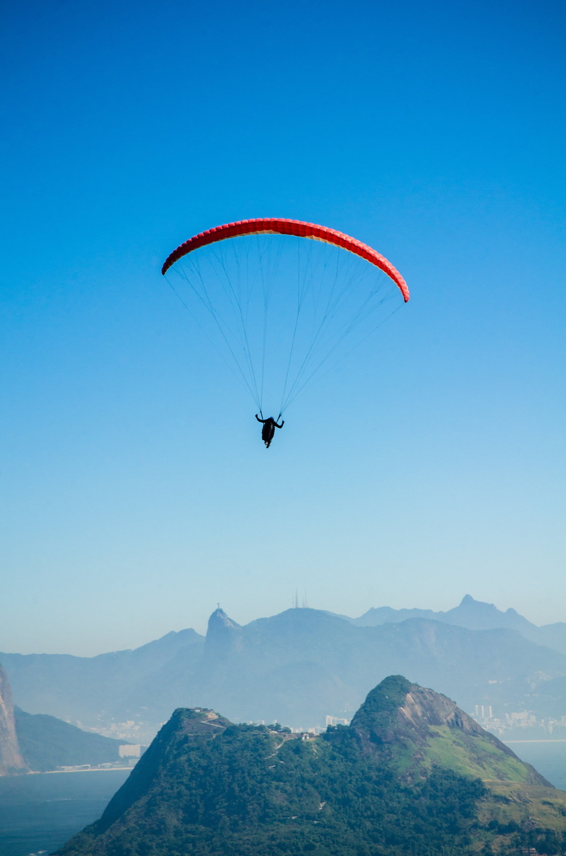 scenics - nature, adventure, exhilaration, mid-air, brazil, one person, lifestyles, parachute, sport, flying, christ the redeemer, leisure activity, sky