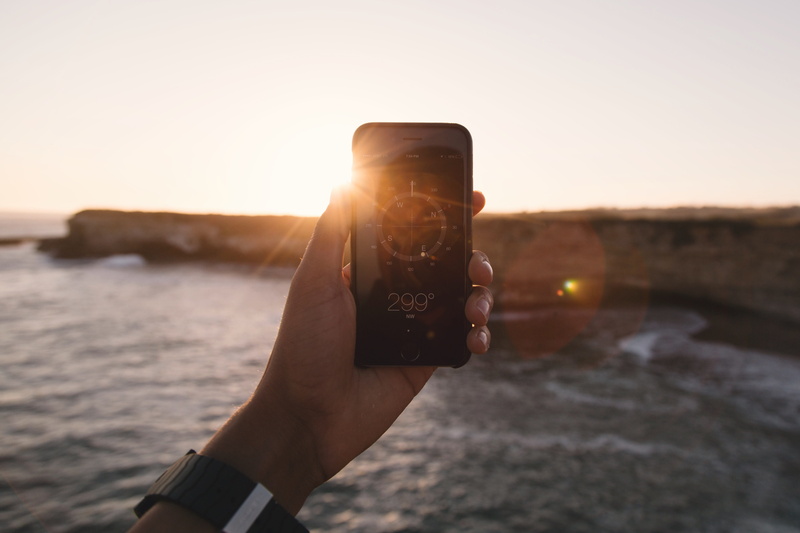 outdoors, positioning, degrees, sea, mobile phone, communication, portable information device, shore, nature, sun, compass, person, connection, technology