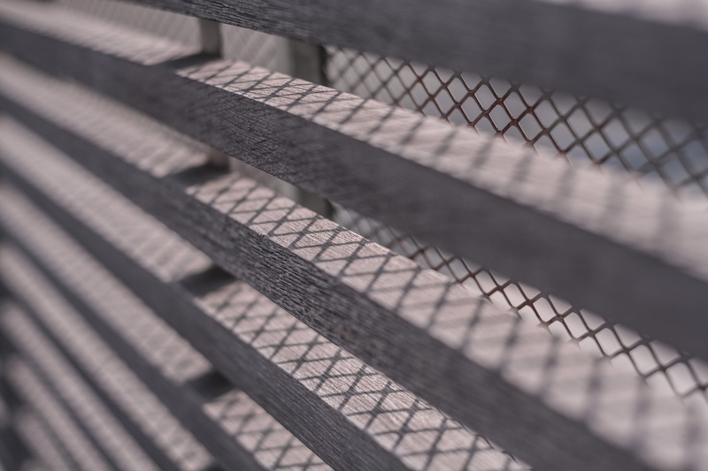line, perspective, geometric, grills, railing, repetition, no people, shadow, pattern, sunlight, high angle view, architecture, focus on foreground, window