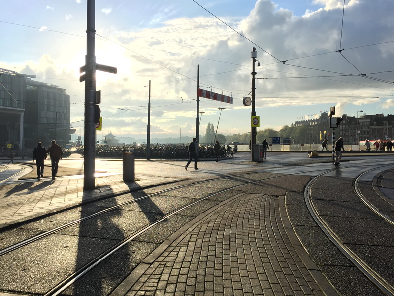 architecture, outdoors, people, blue, railroad Track, walking on, cityscape, walking, daytime, city, urban Scene, white clouds, clouds, transportation