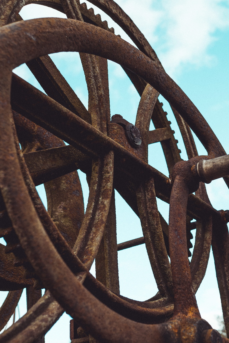 deterioration, low angle view, machinery, ruined, pulley, nature, wrought iron, turning, run-down, decline, cogs, shape, orange, metalwork, geometric shape