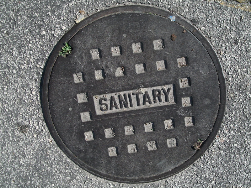 circle, lid, high angle view, capital letter, no people, iron, street, drain, manhole, round, maintenance-hole, directly above, sewage, communication, text