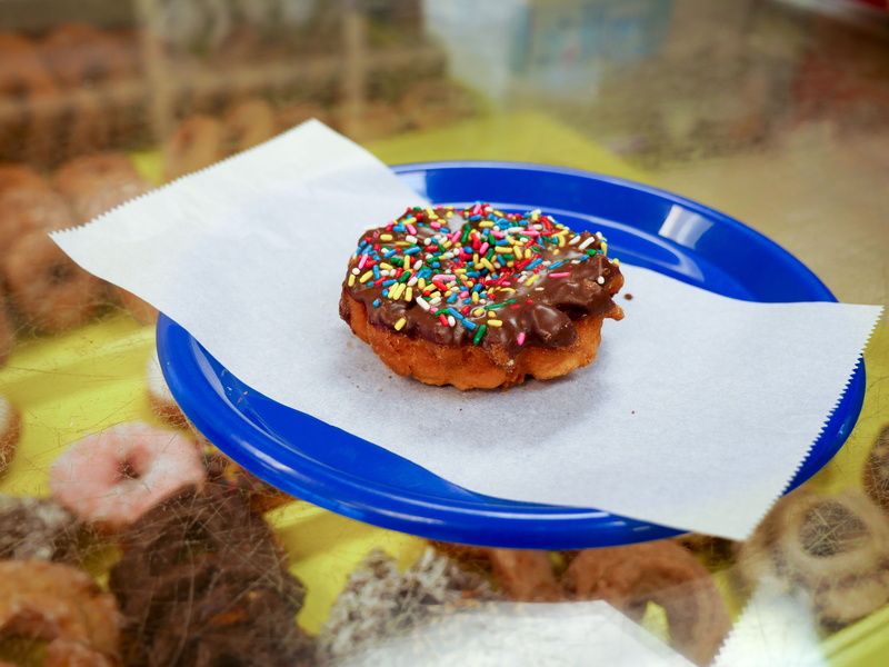 focus on foreground, unhealthy, food and drink, colorful, chocolate, freshness, sprinkles, pastry, bakery, food, frosted, blue, indulgence, doughnut, table