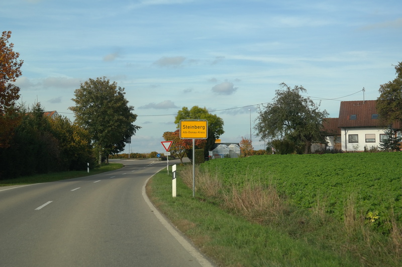 Entrance, Town Sign, road sign, delineator posts, growth, no people, tree, road, shield, outdoors, sky, swabian alb, nature, cloud - sky, rural Scene, direction