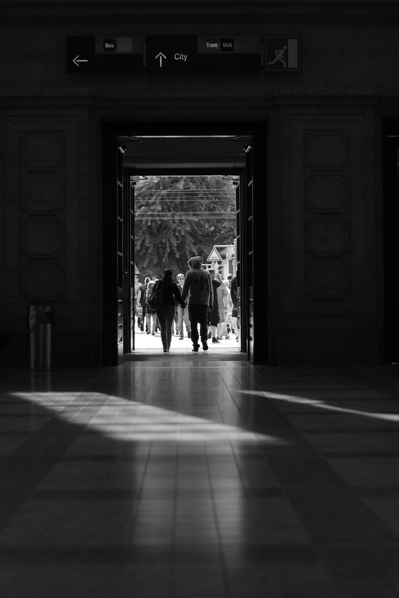 adult, indoors, in, romantic, group of people, door, entrance, sunlight, together, railway station, real people, to the, walking, day, rear view, men, tiled floor