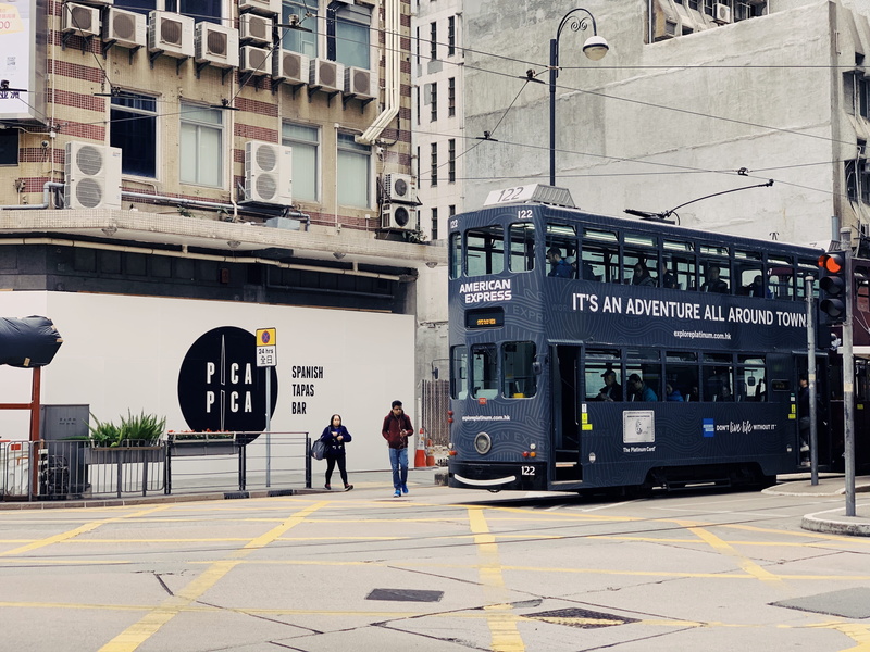 beside, land vehicle, city, advertisement, mode of transportation, bus, building, person, building exterior, tour bus, information, vehicle, text, day