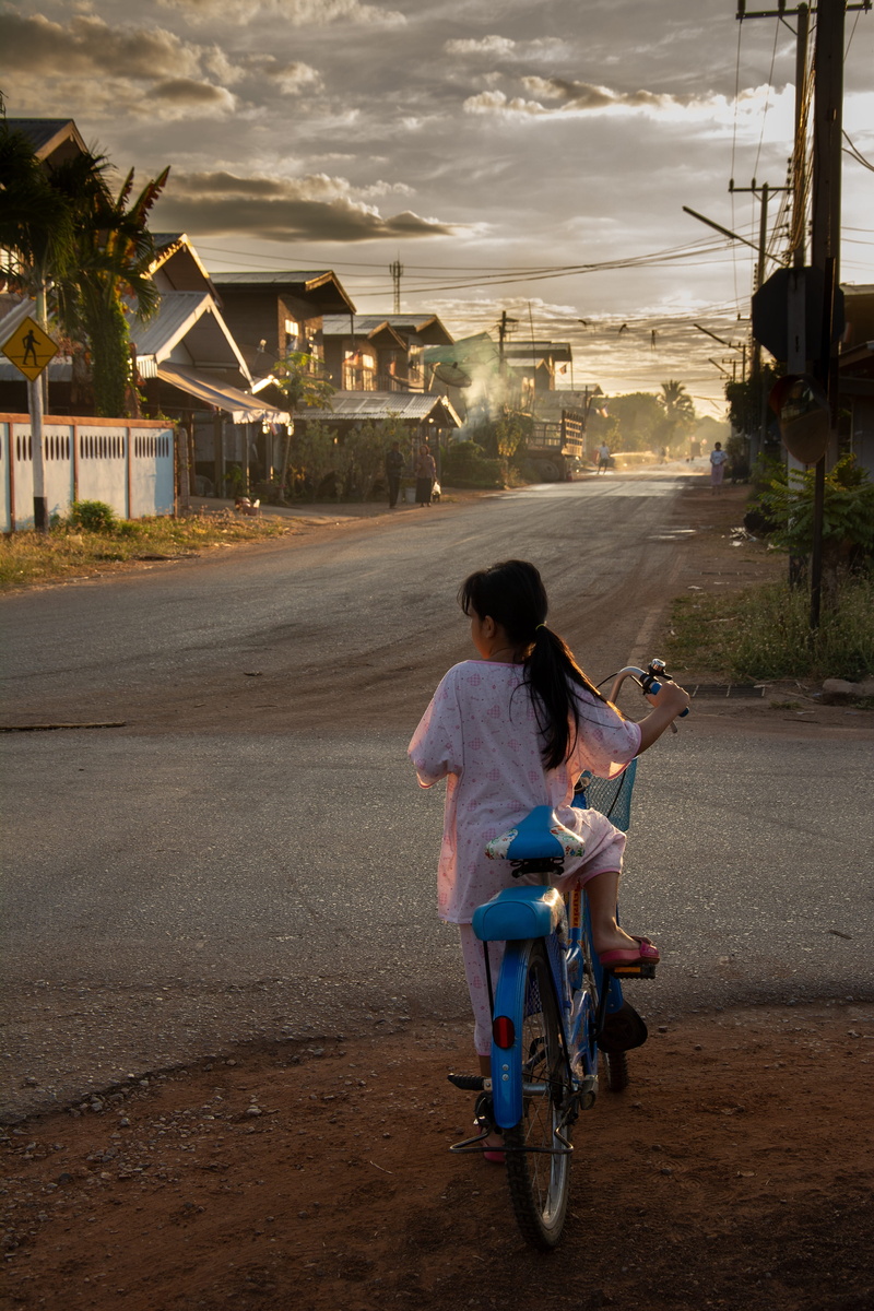 road, one person, outdoors, ride, mode of transportation, crossroad, real people, casual clothing, thailand, architecture, rear view, morning, asia, street