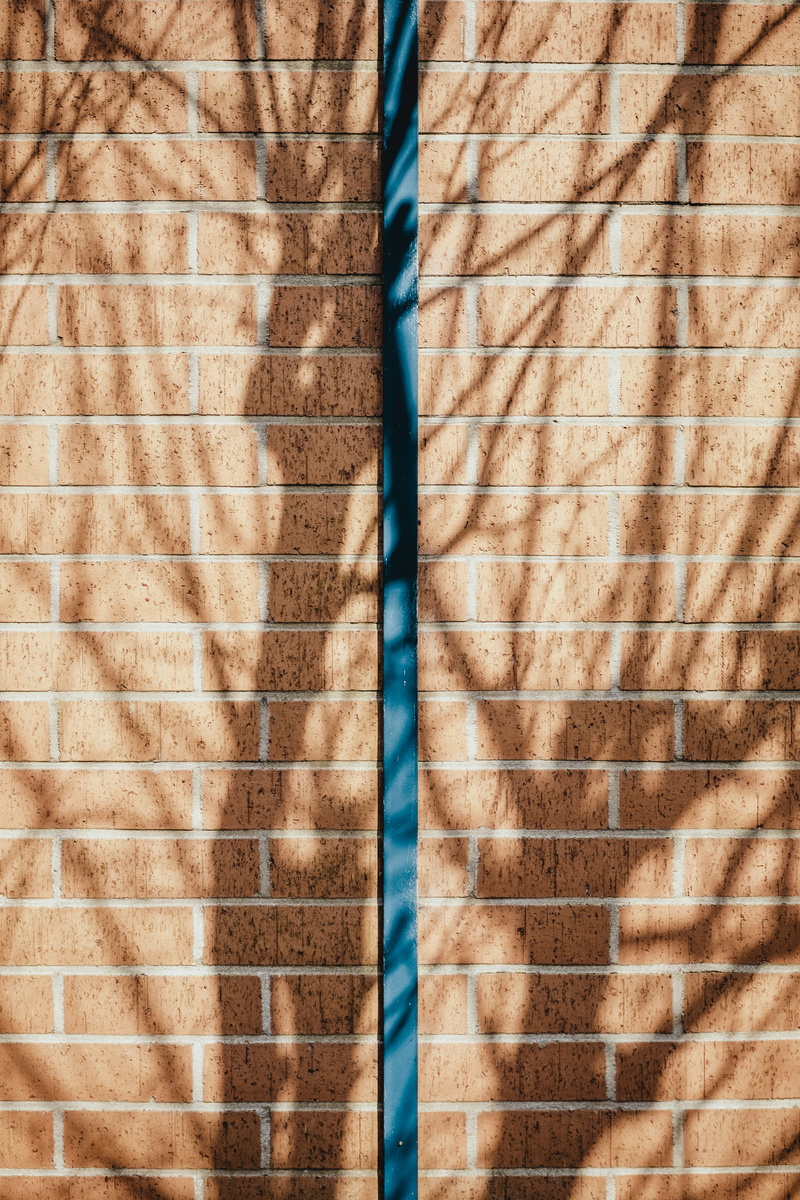 louvain-la-neuve, brick wall, wall - building feature, street, bar, texture, pattern, shadow, day, tablet, wall, building exterior, close-up, symmetry
