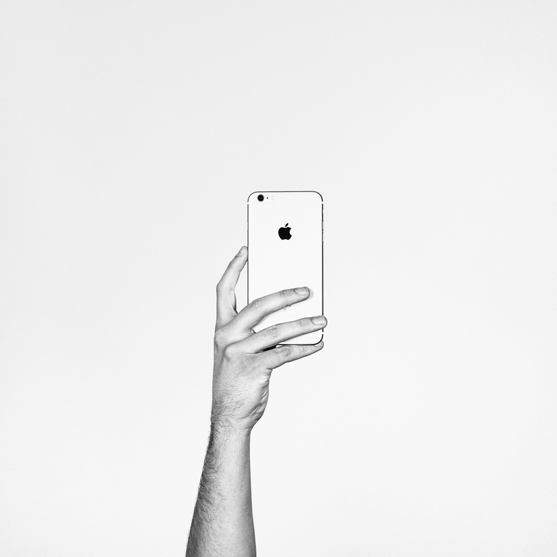white background, modern, glass, technology, connection, one person, holding, wireless technology, finger, mobile phone, human limb, body part, copy space