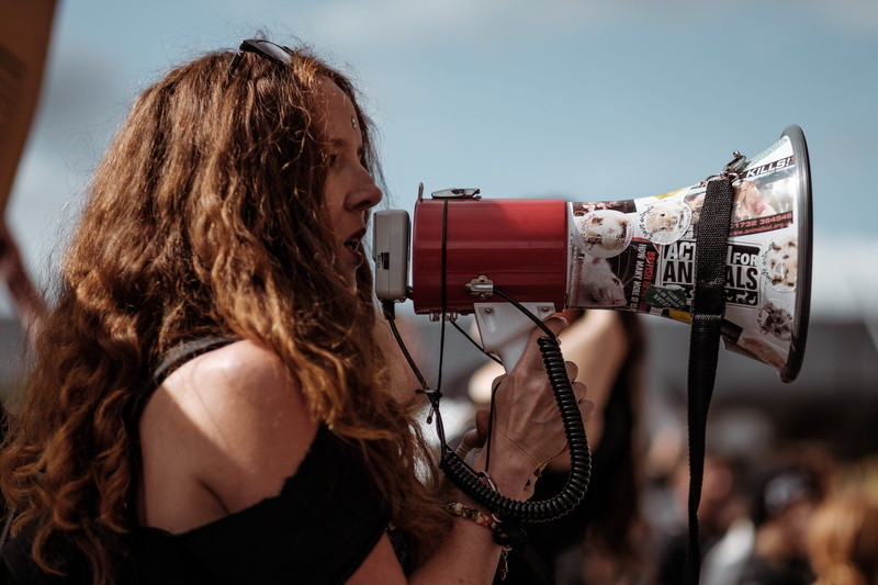 march, music, beautiful woman, photography, performance, adult, daytime, speaker, input device, hairstyle, women, shirt, microphone, focus, shoulder, brown hair
