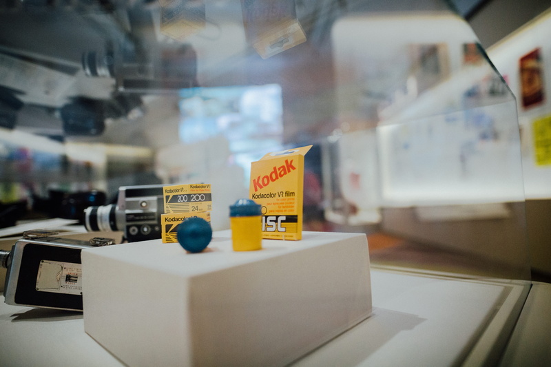 sign, plywood, indoors, retail, camera, trademark, selective focus, architecture, food and drink, pc, city, glass - material, lab, kiosk, symbol, close-up