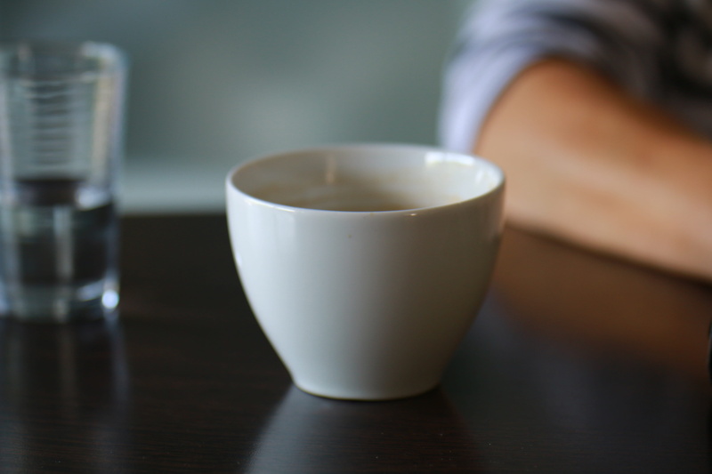 dialogue, mug, focus on foreground, glass, human body part, tea cup, refreshment, food and drink, table, coffee cup, crockery, indoors, hot drink, wood - material