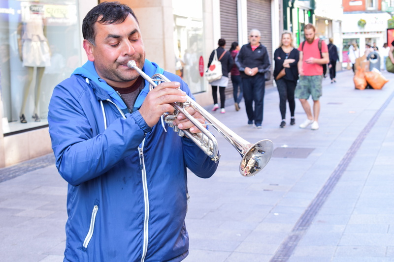 street musician, mature adult, standing, day, clothing, music, incidental people, males, group of people, instrument, artist, person, City, trumpet, real people
