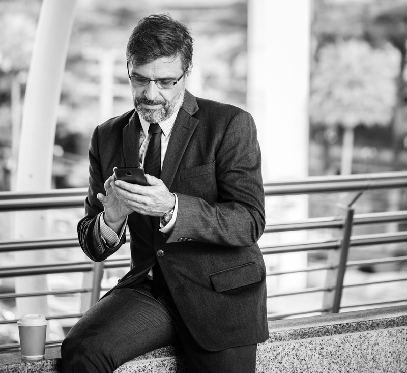 urban, mature adult, phone, real people, front view, cbd, business, men, one person, mature men, chatting, bridge, focus on foreground, messaging, corporate