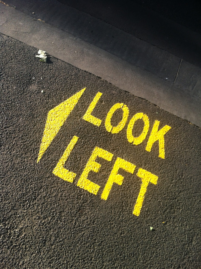 outdoors, no people, communication, sign, capital letter, 2K, western script, city, high angle view, Asphalt, message, yellow, marking, symbol, information
