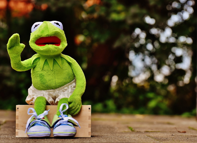 green color, wave, sneakers, sit, stuffed toy, fun, tree, sport, toy, nature, cute, art and craft, focus on foreground, plant, sculpture, pants, human representation