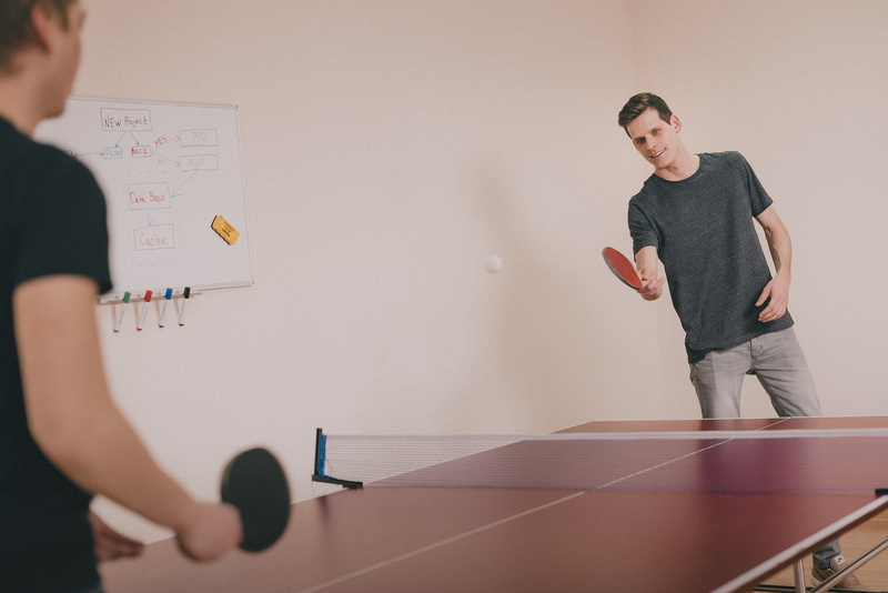 adult, competition, men, inside, holding, two, 2K, two people, office, guys, waist up, young adult, table, game, males, standing, sport, whiteboard, indoors