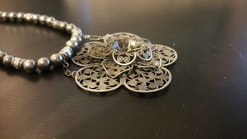 pendant, personal accessory, necklace, fashion, pewter, pearl jewelry, indoors, ring, warm, metal, flower, style, design, precious gem, silver colored