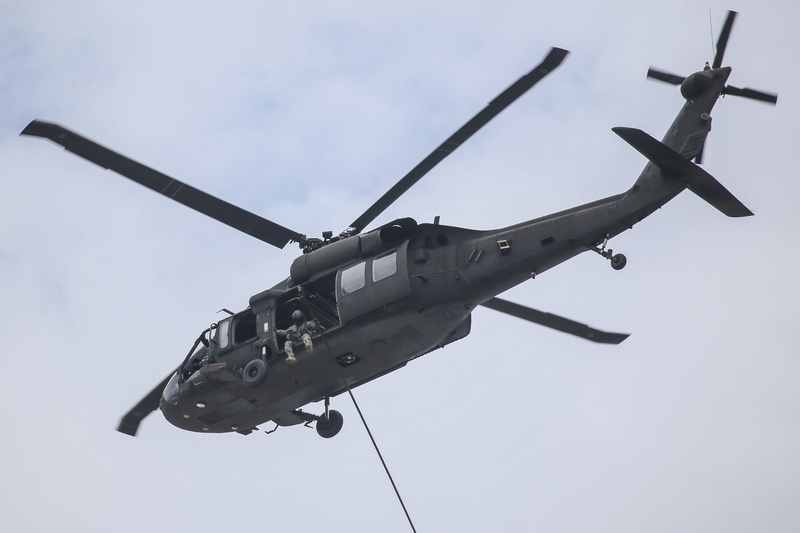 mid-air, rope, motion, uh-60 blackhawk, aerospace industry, low angle view, aggression, outdoors, air force, no people, weapon, sky, helicopter, spec ops