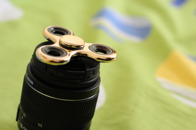 single object, science, metal, gold, photography themes, camera - photographic equipment, man made object, hand, toy, no people, 5K, games, indoors, spinner