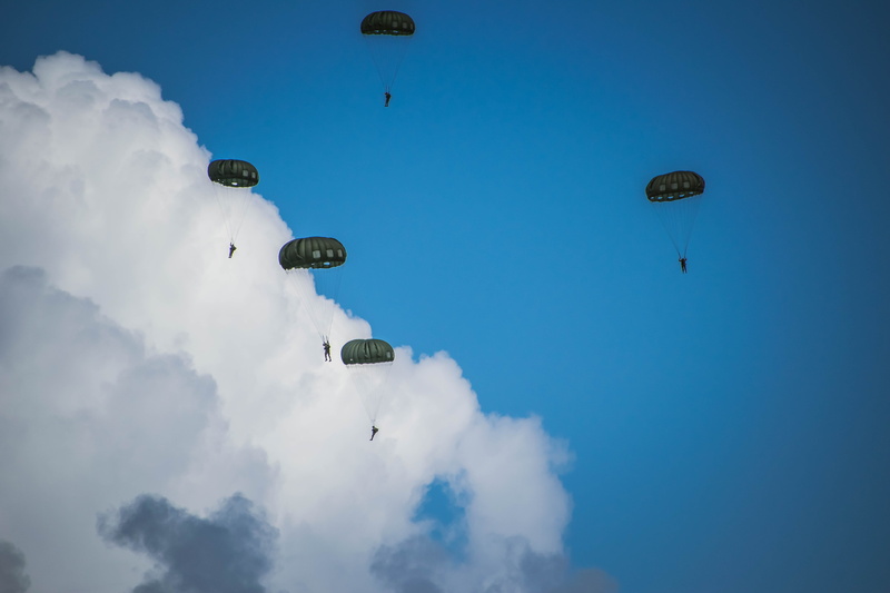 mid-air, mode of transportation, parachute, sky, unrecognizable person, low angle view, people, paragliding, nature, army, two people, extreme sports, blue