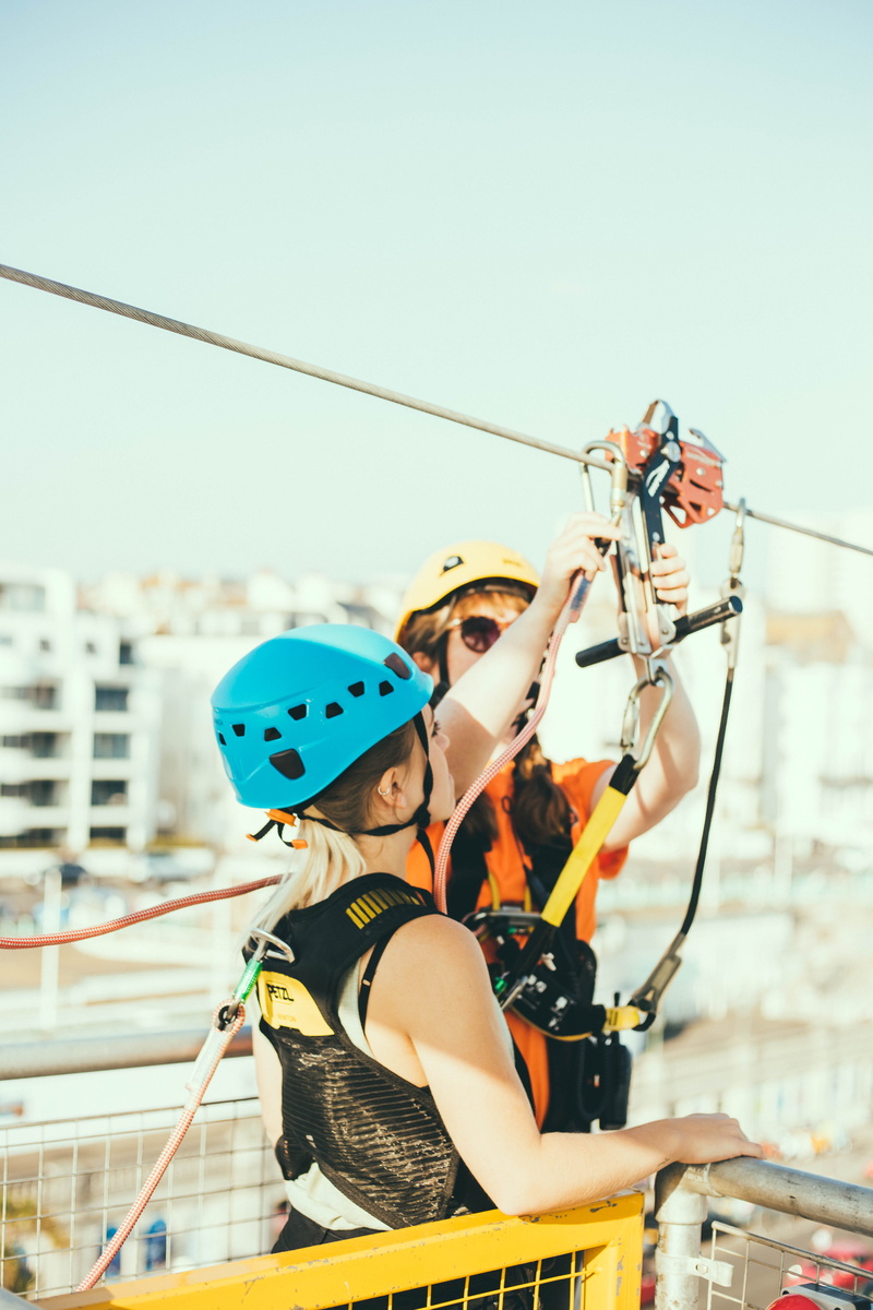 women, wearing, bungee, outdoors, life, enjoyment, sports helmet, climbing, young women, ramp, real people, people, clear sky, harness, lifestyles, extreme