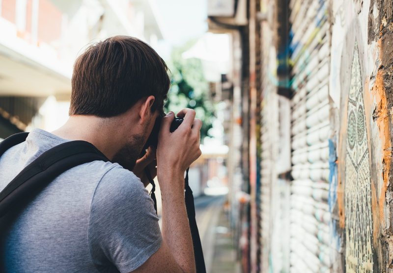 daytime, leisure activity, architecture, hair, lifestyles, photographer, focus on foreground, standing, camera, photowalk, painting, wall, portrait, young adult