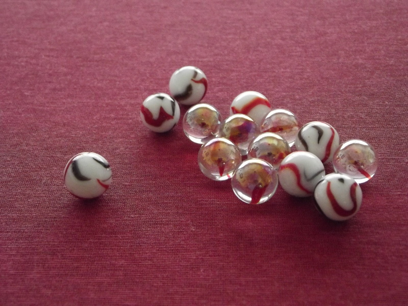 group, sphere, table, directly above, toys, jewelry, shell, personal accessory, leadership, chief, red, high angle view, marble, no people, leisure games
