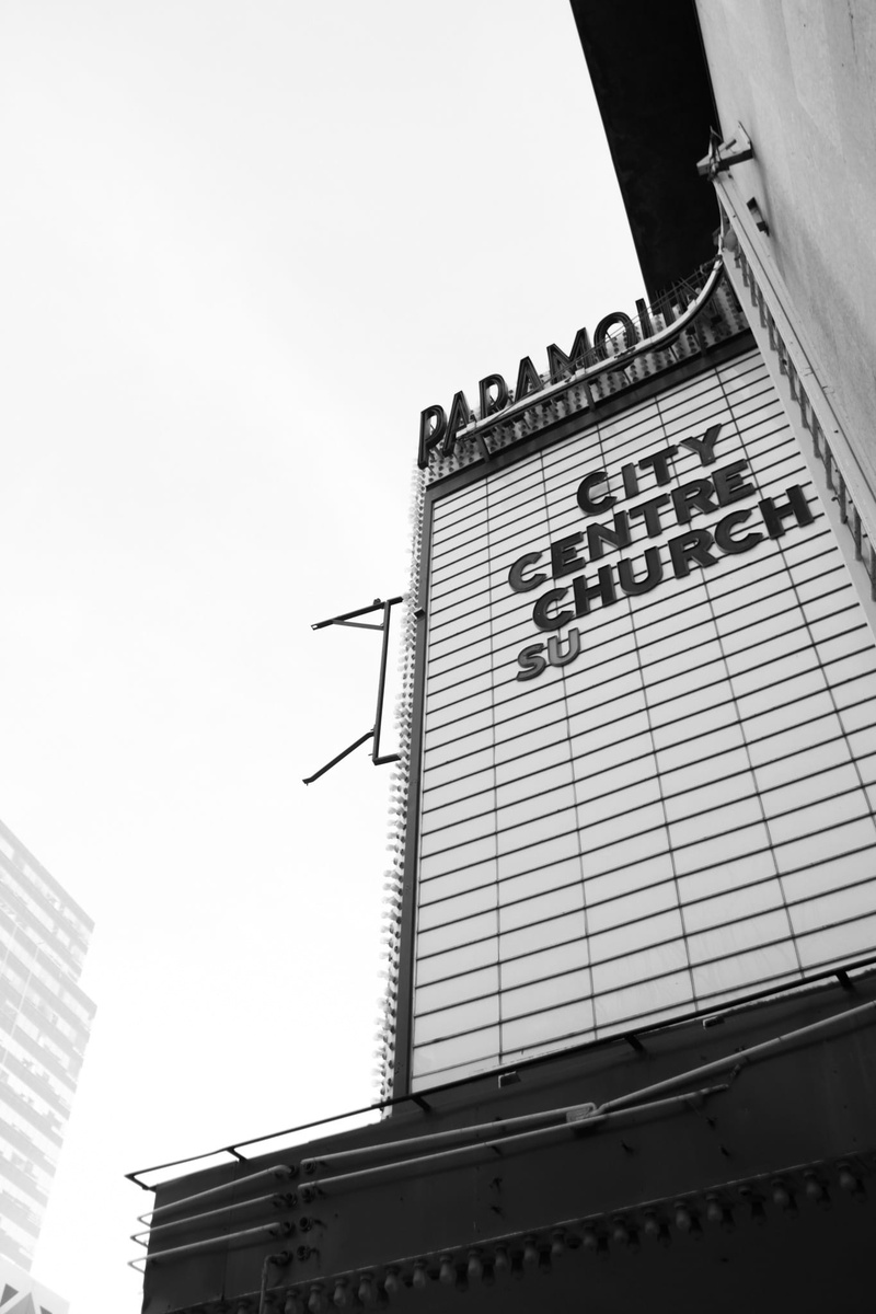city centre church, built structure, tall - high, no people, nature, skyscraper, theatre, sky, outdoors, sign, clear sky, architecture, low angle view