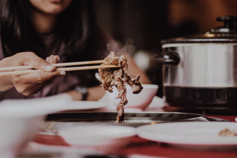 food, Pleasure, only women, indoors, hand, one Person, selective focus, cooked, woman, caucasian Ethnicity, picking, beige, chopsticks, preparing food