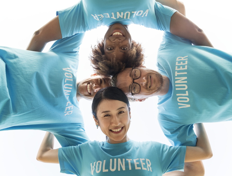 arms around, people, caucasian, afro, lifestyles, diverse, low angle view, front view, portrait, standing, community service, happiness, text, headshot