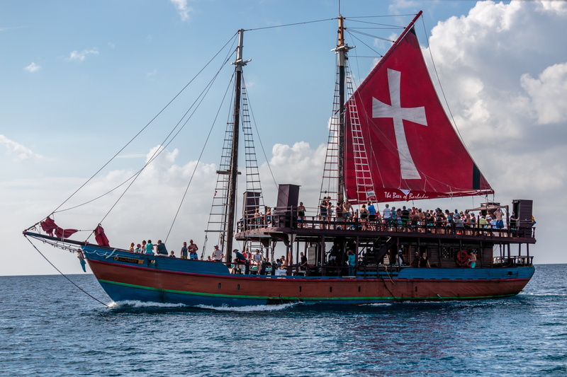 sky, mast, nautical Vessel, group of people, sailing, waterfront, sea, outdoors, flag, sailboat, daytime, people, day, cloudy, nature, real people, sail