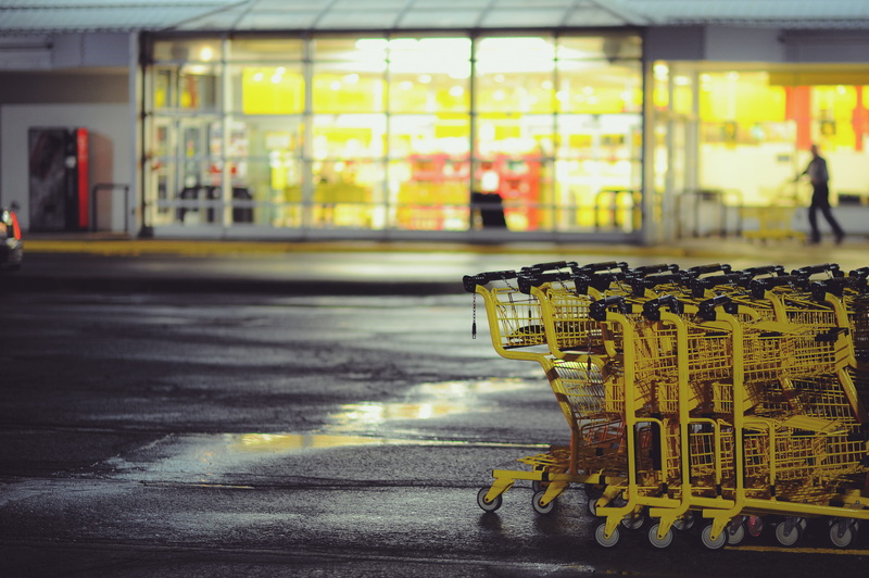 puddle, parking lot, carts, front, evening, building, 2K, city, architecture, shopping, shopping trolley, incidental people, yellow, consumerism, retail
