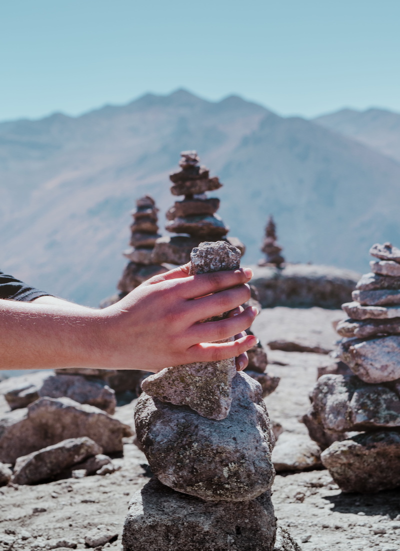 rock - object, land, stack, real people, apacheta, outdoors, create, mountain, relaxing, latinoamerica, stones, happy, day, leisure activity, focus on foreground