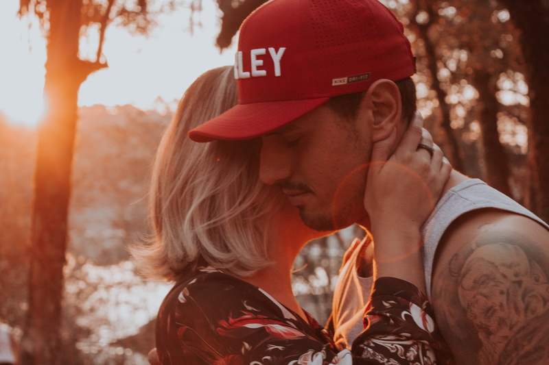 tattoo, human, love, young adult, sun, sunlight, hand, men, focus on foreground, hat, woman, lifestyles, man, hold, profile view, adult, together, people