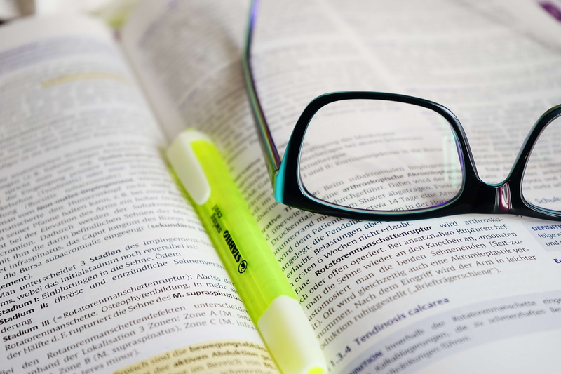 indoors, pen, read, reading glasses, still life, education, glasses, text, day, western script, close-up, book, publication, training, formed, focus on foreground