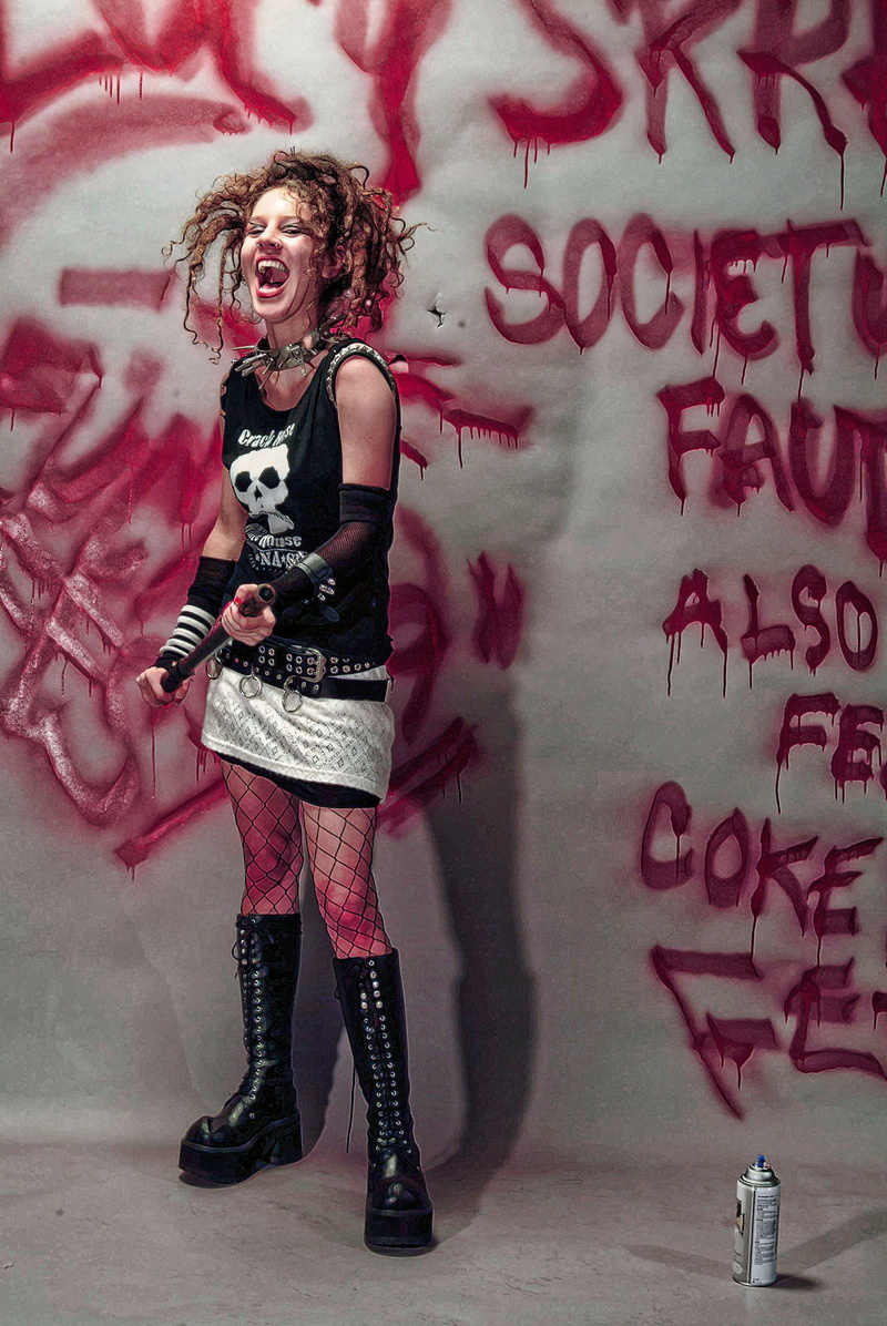 boots, looking at camera, skirt, one person, indoors, young, young women, graffiti, t-shirt, lifestyles, backdrop, wall - building feature, portrait, women