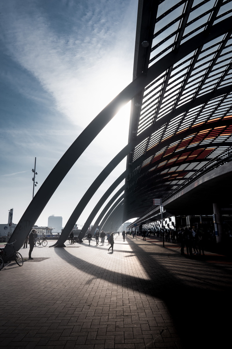 built structure, person, shadow, connection, people, street, sun, outdoors, light, the netherlands, building exterior, cloud - sky, day, urban, sunlight