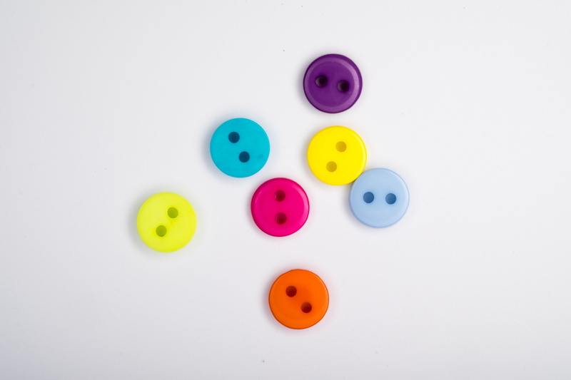 colored buttons, medium group of objects, white background, indoors, shape, directly above, multi colored, clothes, choice, sew, purple, holiday, colored scattering