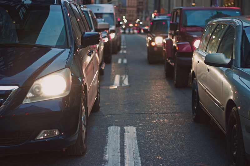 traffic jam, sunlight, day, street, cars, transportation, headlight, car, tailback, in a row, outdoors, architecture, land vehicle, road, city street, motor vehicle