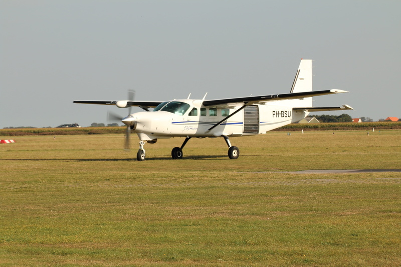clear sky, field, aerospace industry, motion, airplane, outdoors, mode of transportation, sport airplane, private airplane, no people, air vehicle, military