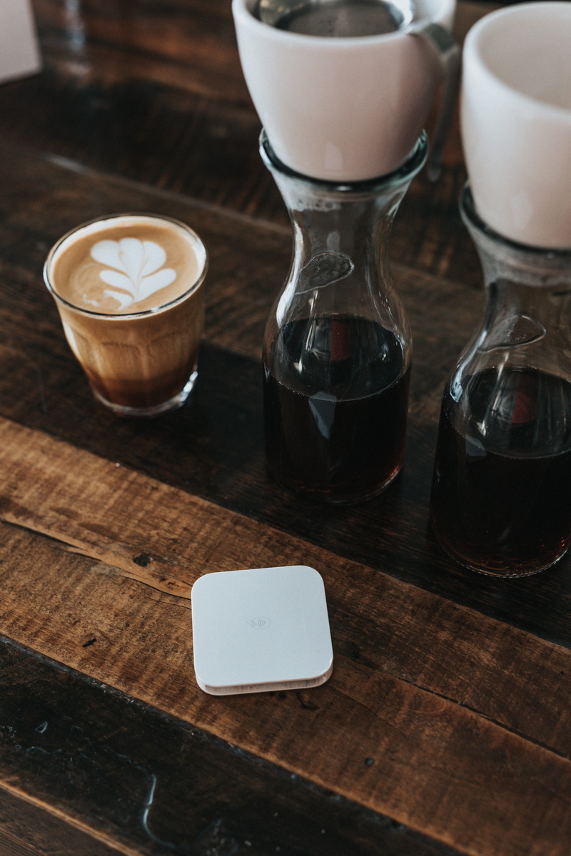 square, refreshment, coffee - drink, payment, latte, food and drink, drinking glass, cup, household equipment, alcohol, transparent, phone, close-up, electronics